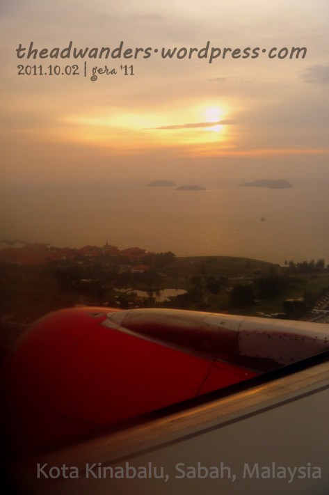 The Red of AirAsia over the orange sun setting at Kota Kinabalu