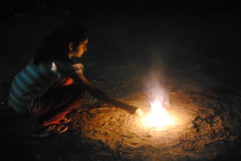 My landlady's daughter Pratiksha lighting firecrackers (Uncle and Auntie were supervising)